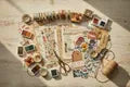 Flat lay of scrapbooking and junk journaling supplies including patterned papers, washi tape, rubber stamps, ink pads, dried flowers, and vintage ephemera