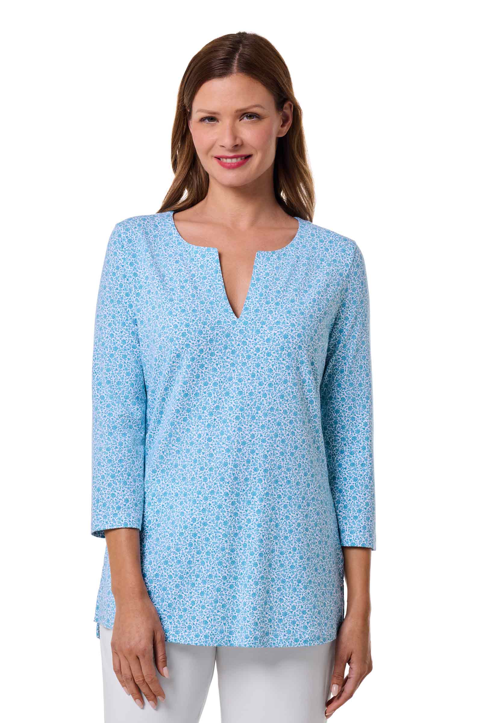 Woman wearing a light blue floral patterned blouse on a white background