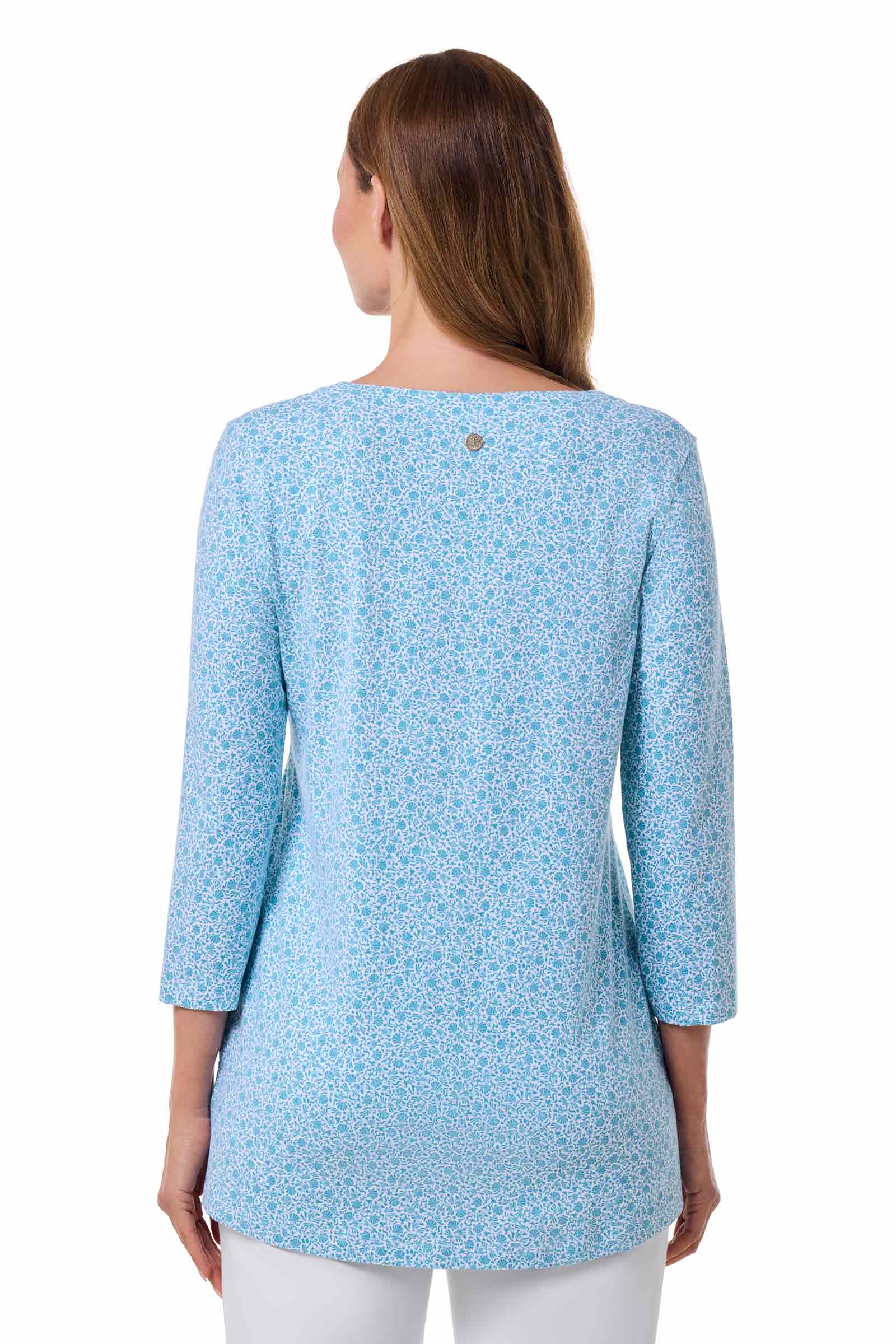 Woman wearing a light blue patterned top on a white background