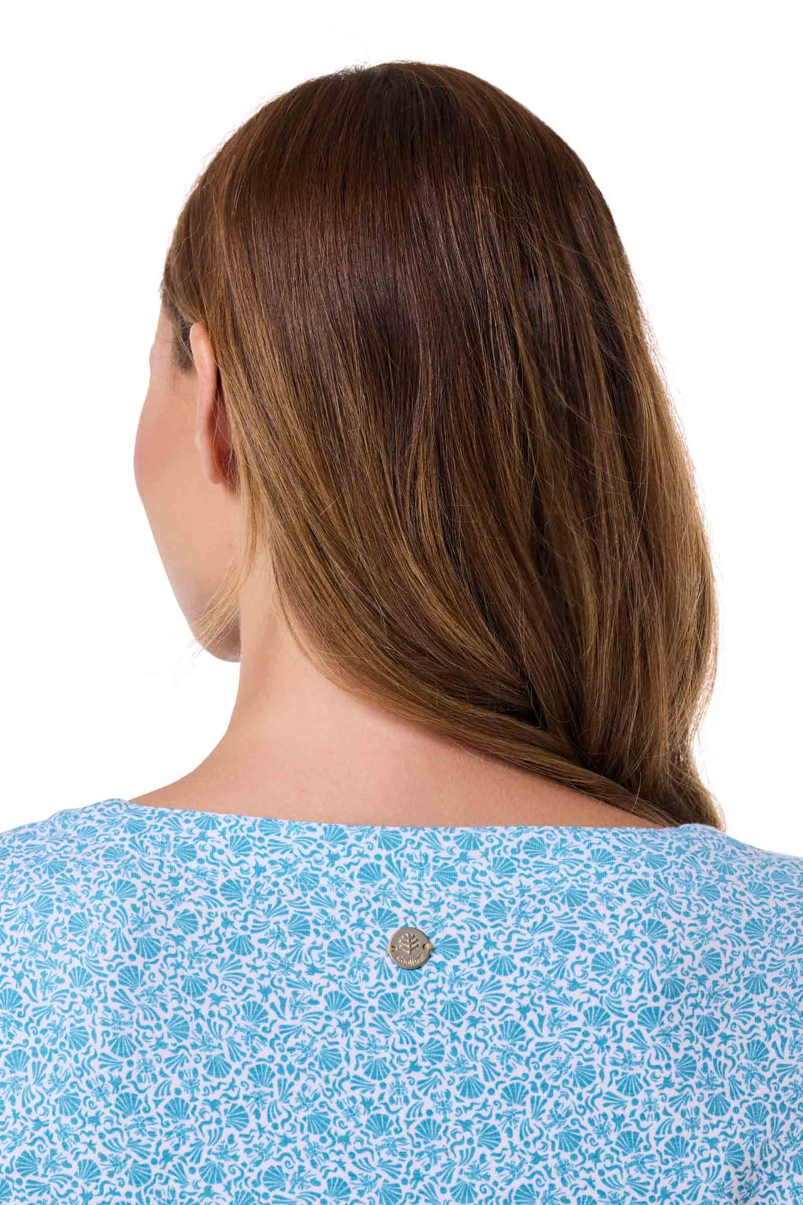 Woman wearing a blue patterned top on a white background