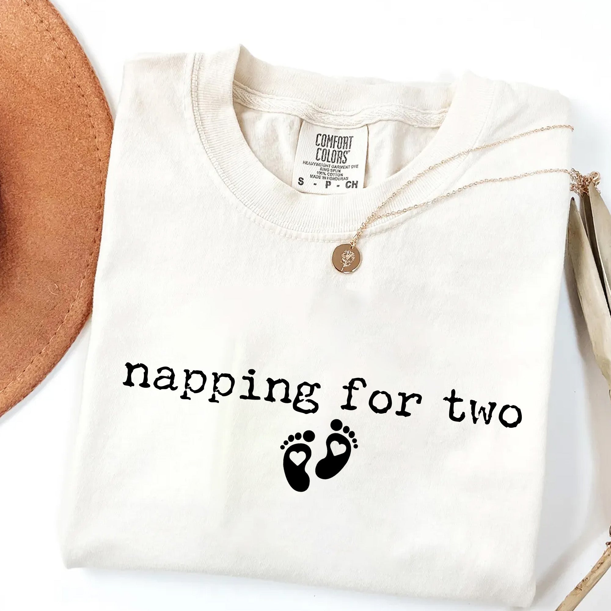 White shirt with 'napping for two' text and footprints on a white background