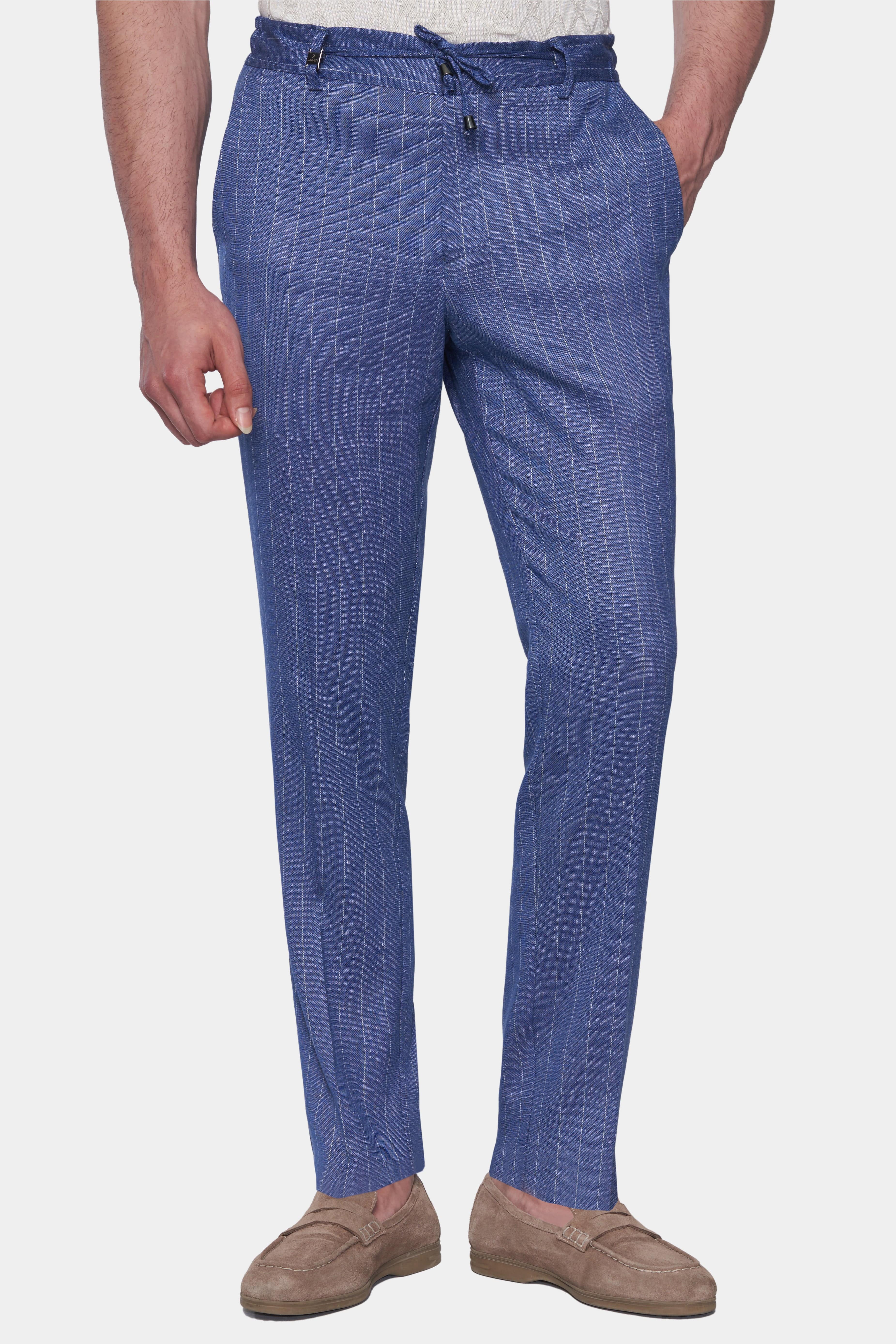 Blue checkered pants worn by a person on a white background