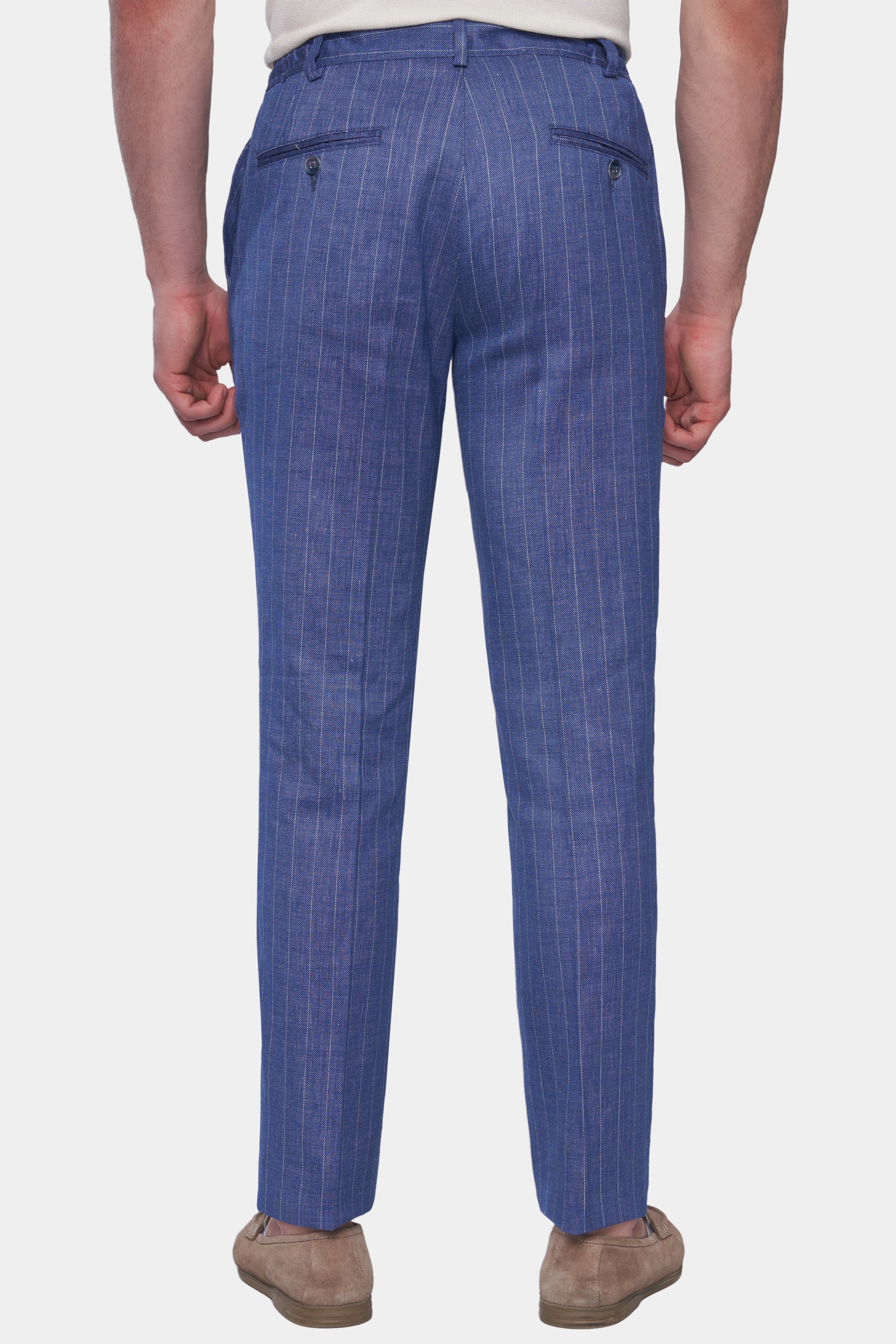 Blue pinstripe pants worn by a person on a white background