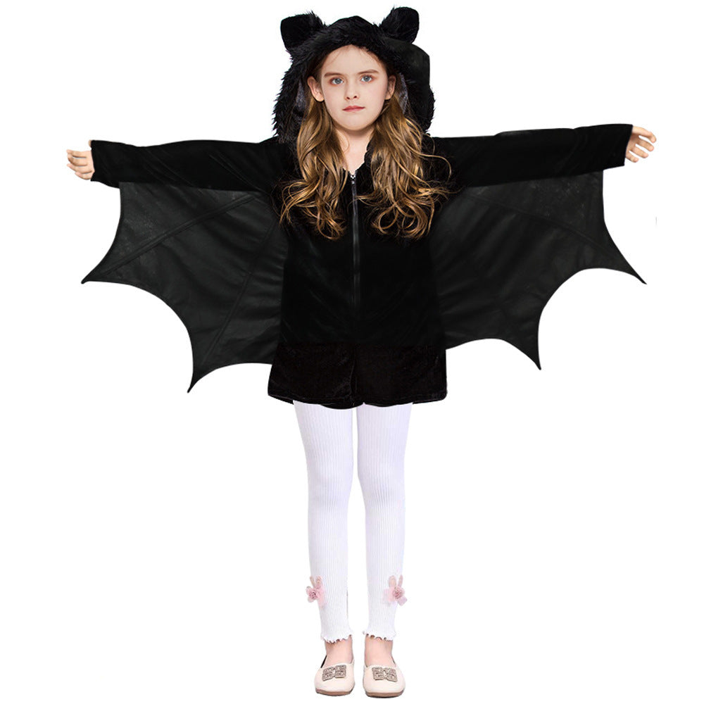 Child wearing a black bat costume with wings on a white background
