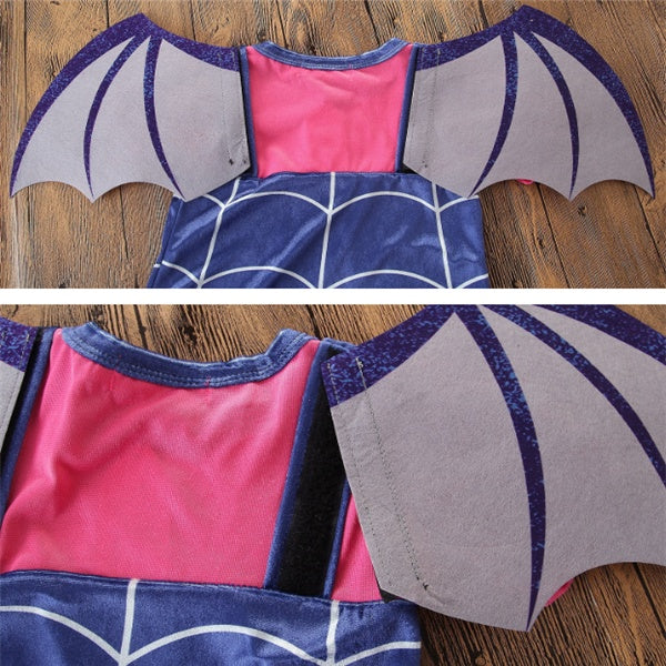 Children's costume with bat wings on a wooden surface