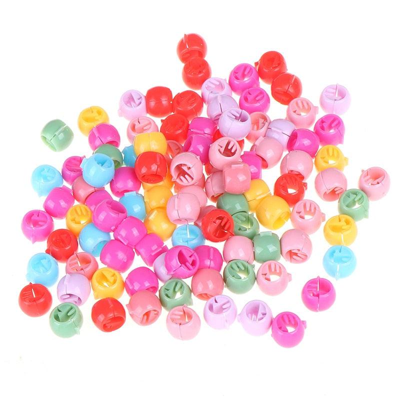 Assorted colorful plastic beads on a white background