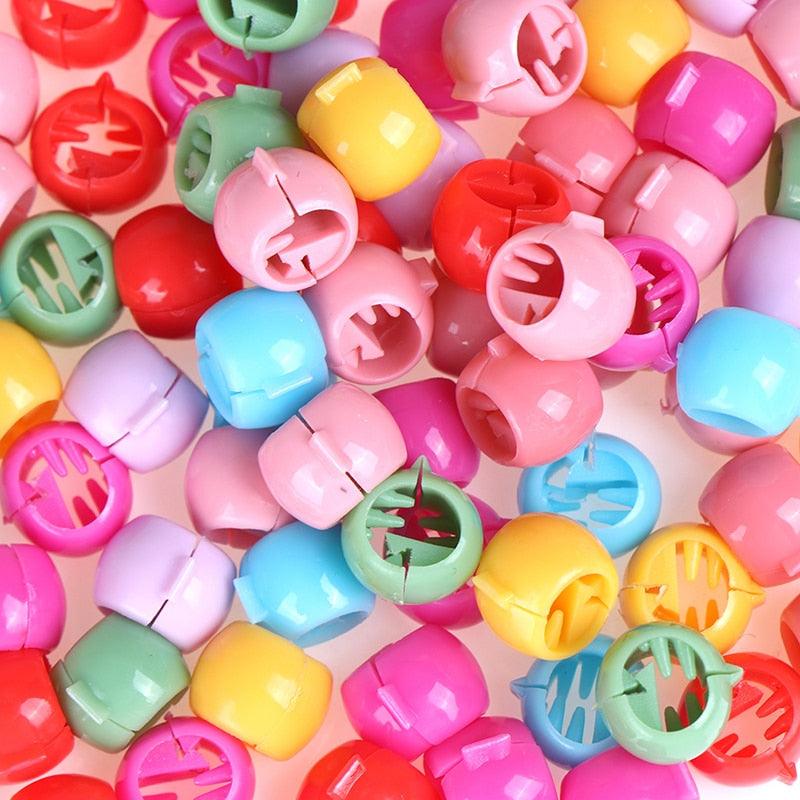 Colorful plastic clips on a pink background
