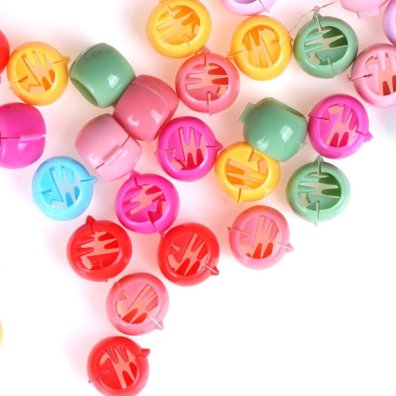 Colorful plastic clips with various shapes on a white background