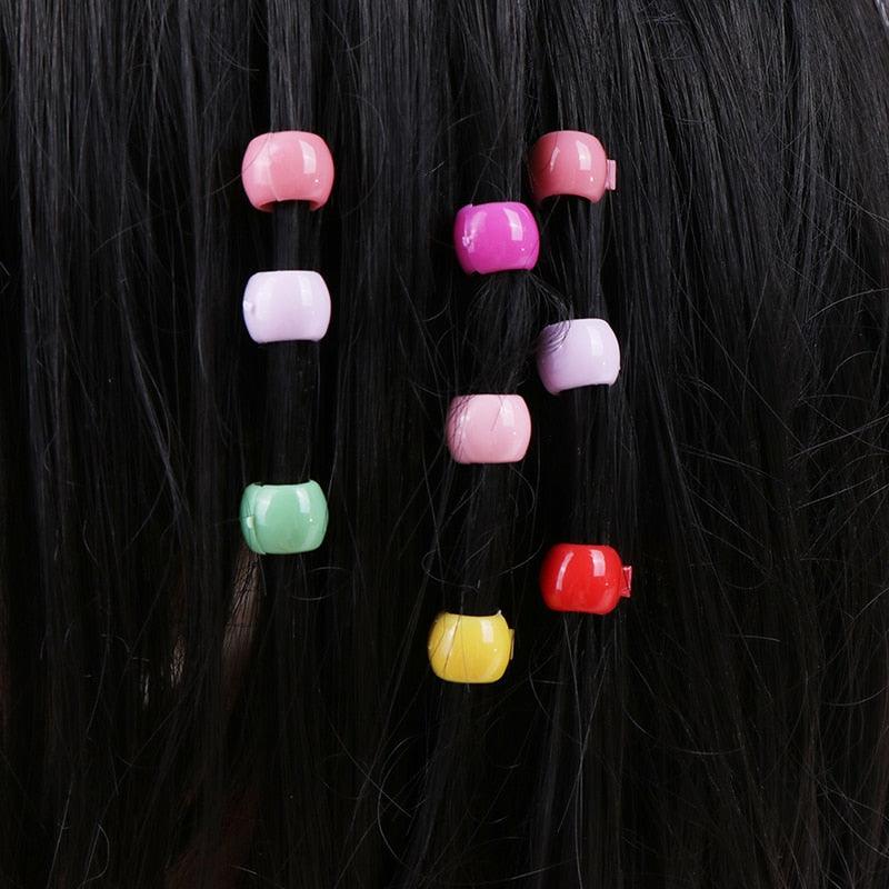 Colorful hair ties on a black hair background