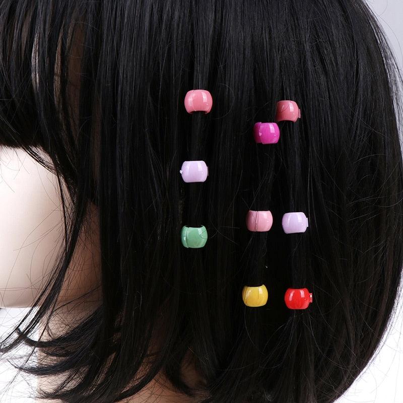 Colorful hair clips on a person's black hair
