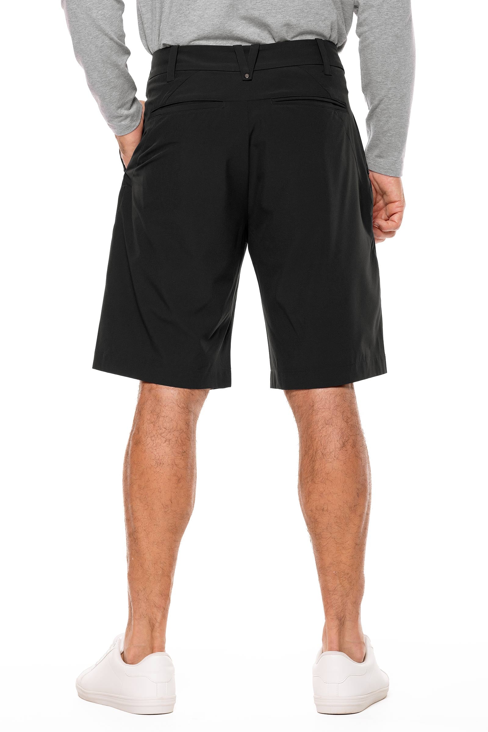 Person wearing black shorts on a white background