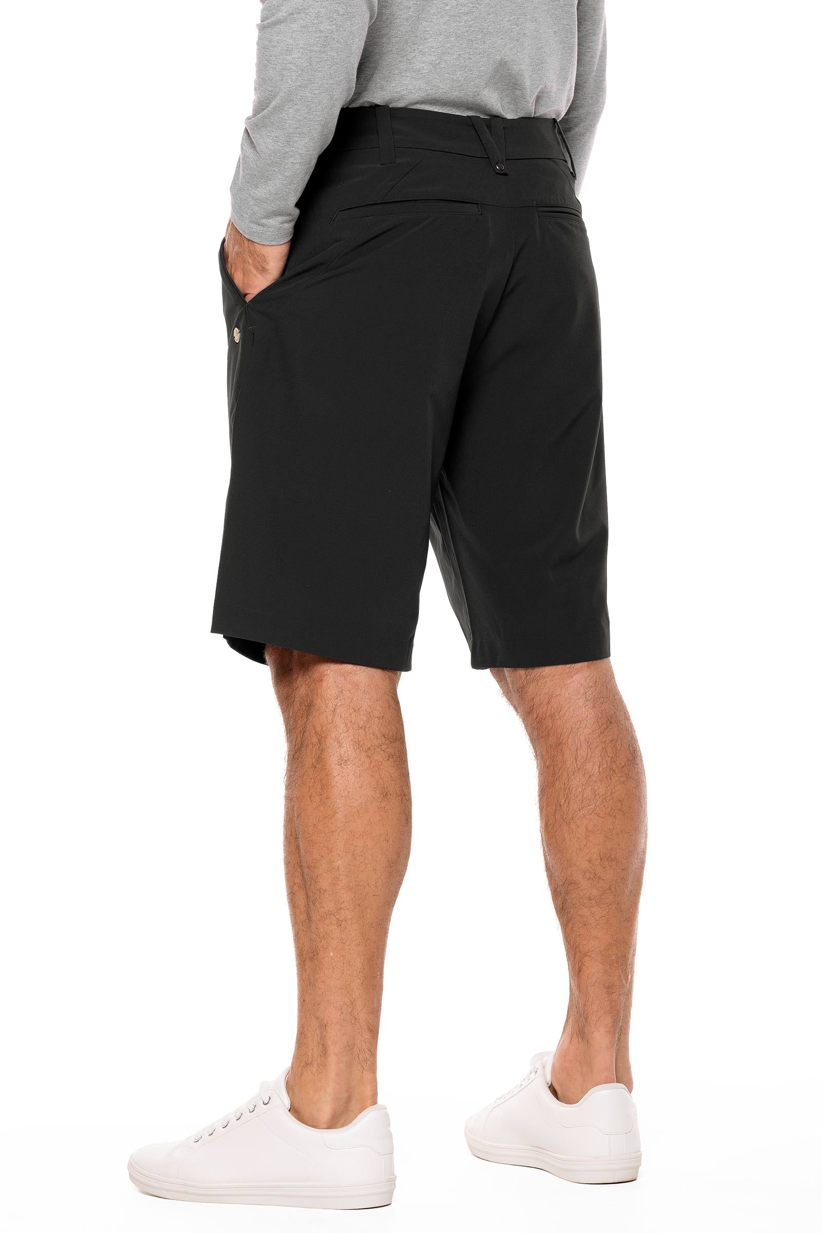 Person wearing black shorts on a white background