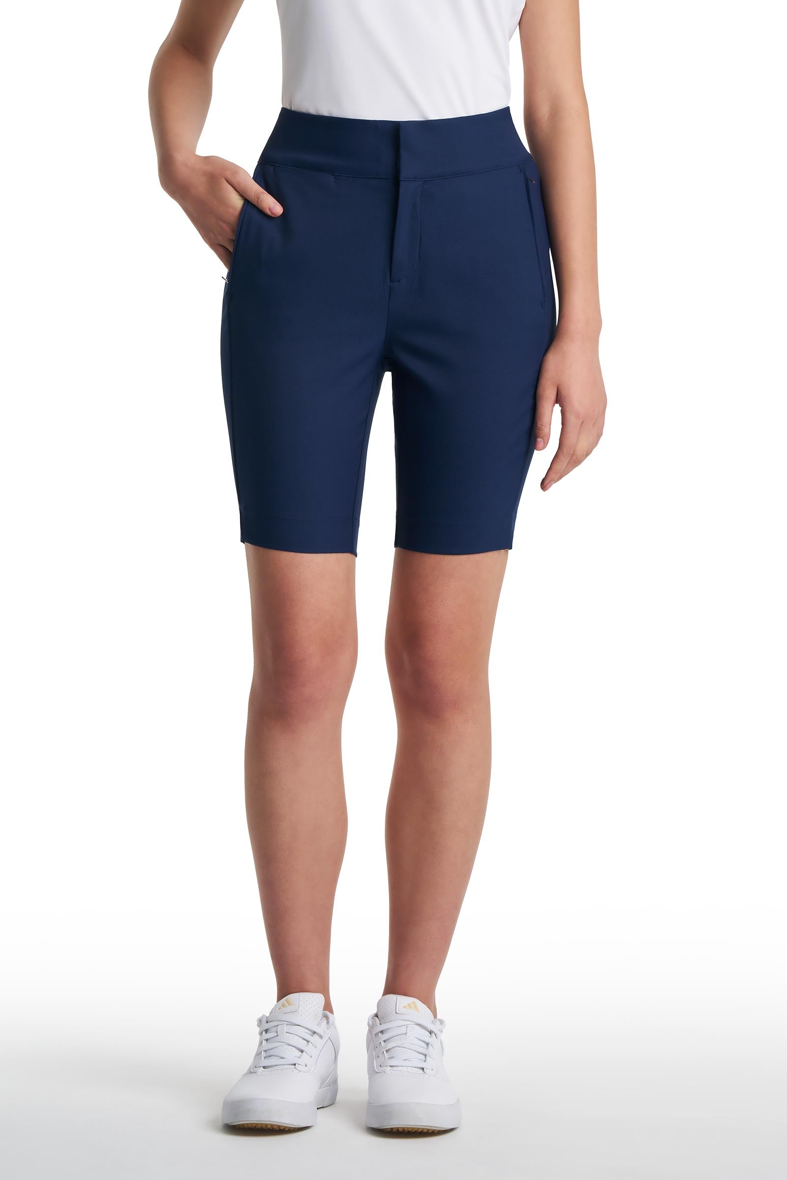 Person wearing navy blue shorts on a white background