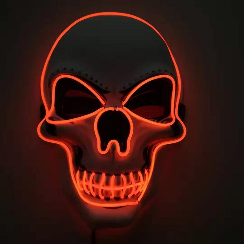 Neon skull mask with orange lights on a black background