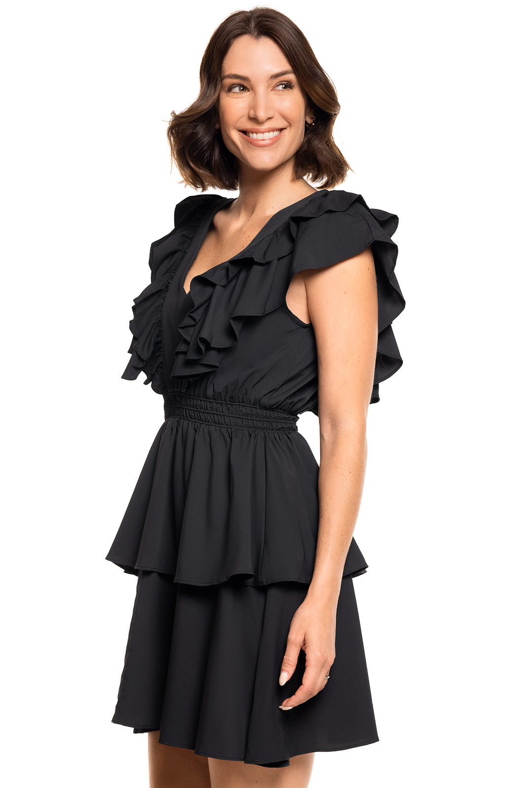 Woman wearing a black dress with ruffled details on a white background