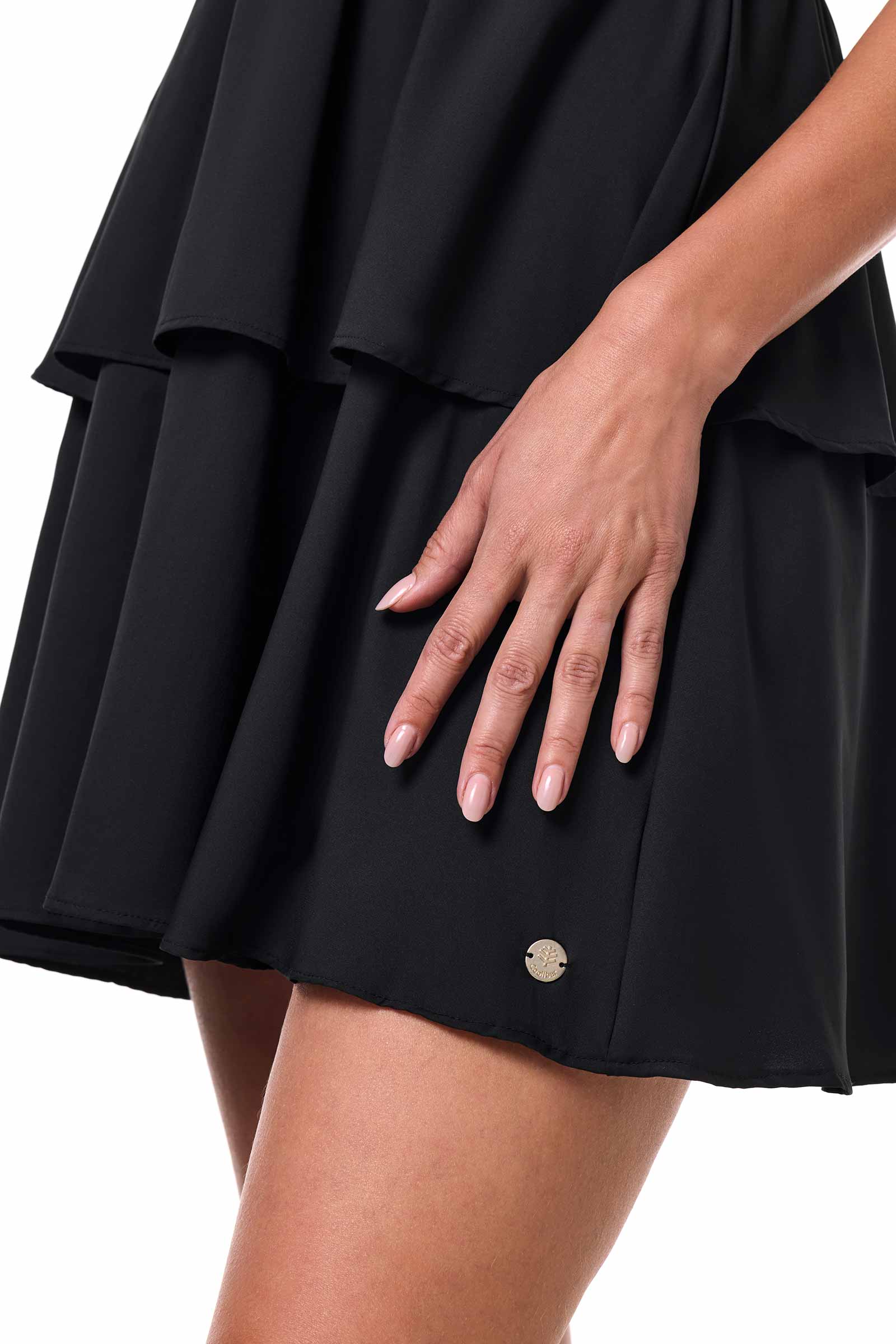 Black skirt with a small button detail on a white background