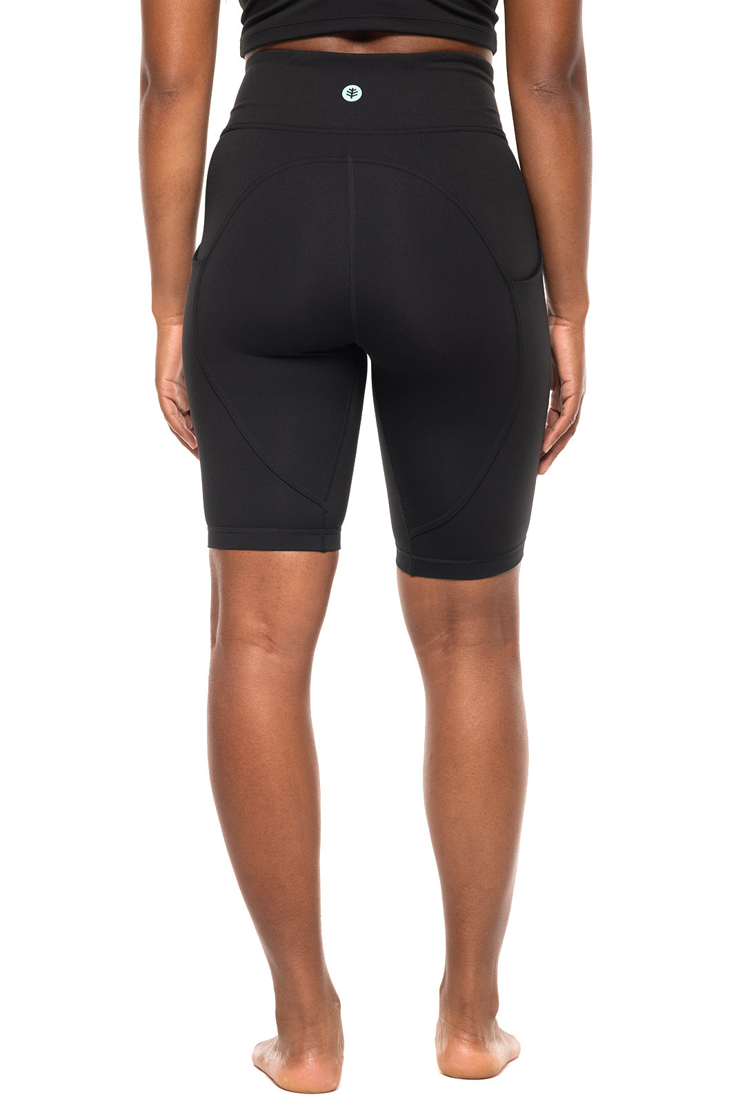 Person wearing black high-waisted shorts on a white background