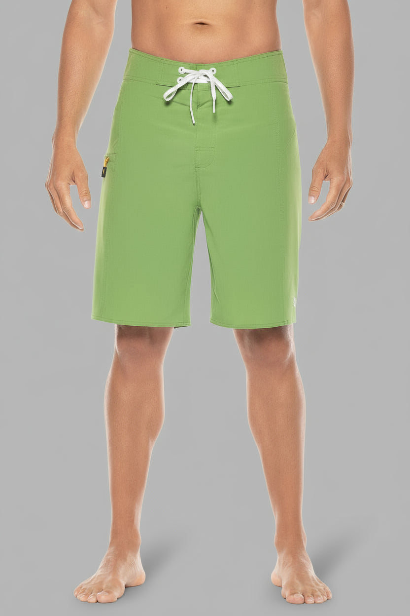 Green shorts worn by a person on a gray background