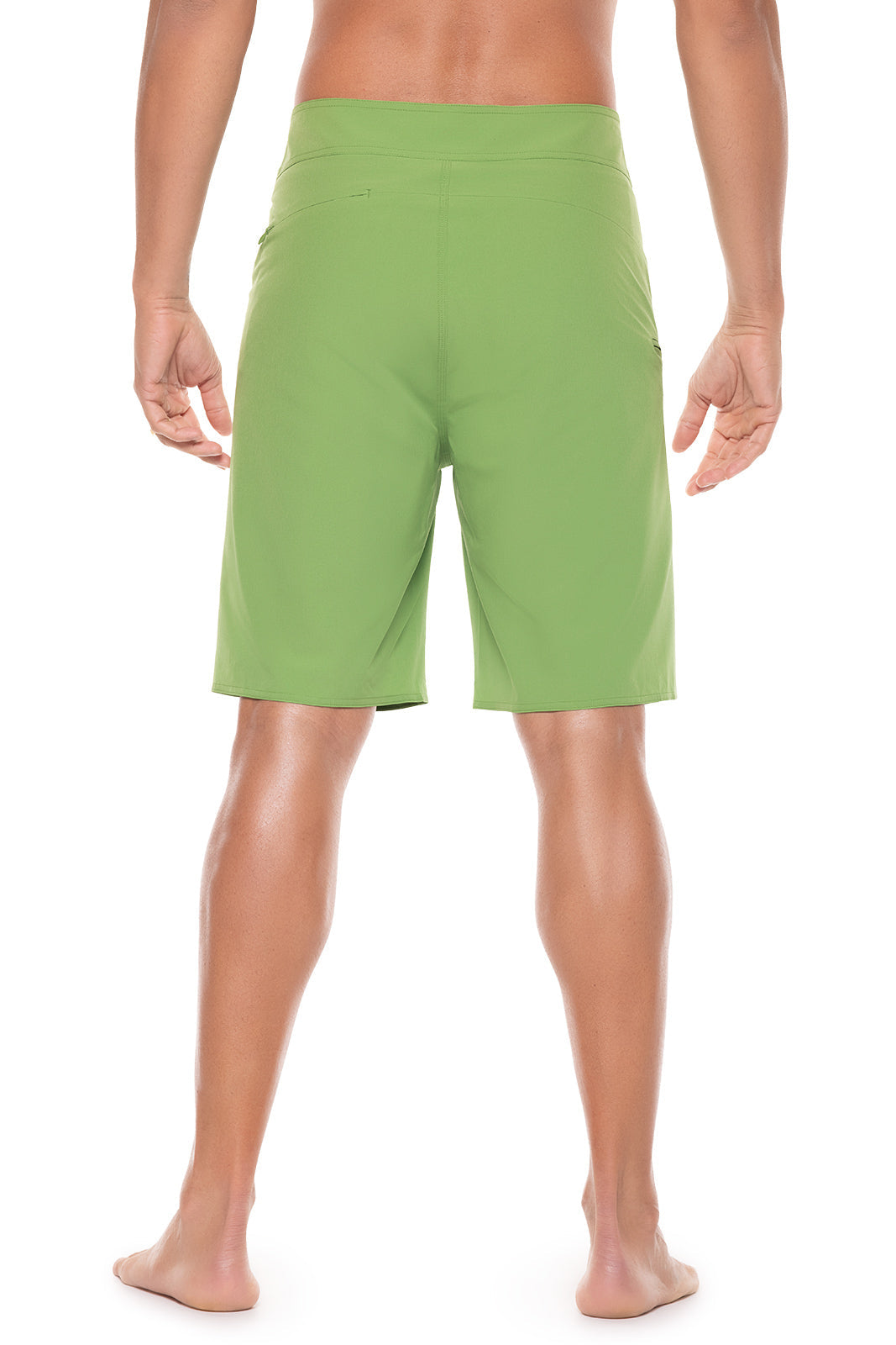 Person wearing green shorts on a white background
