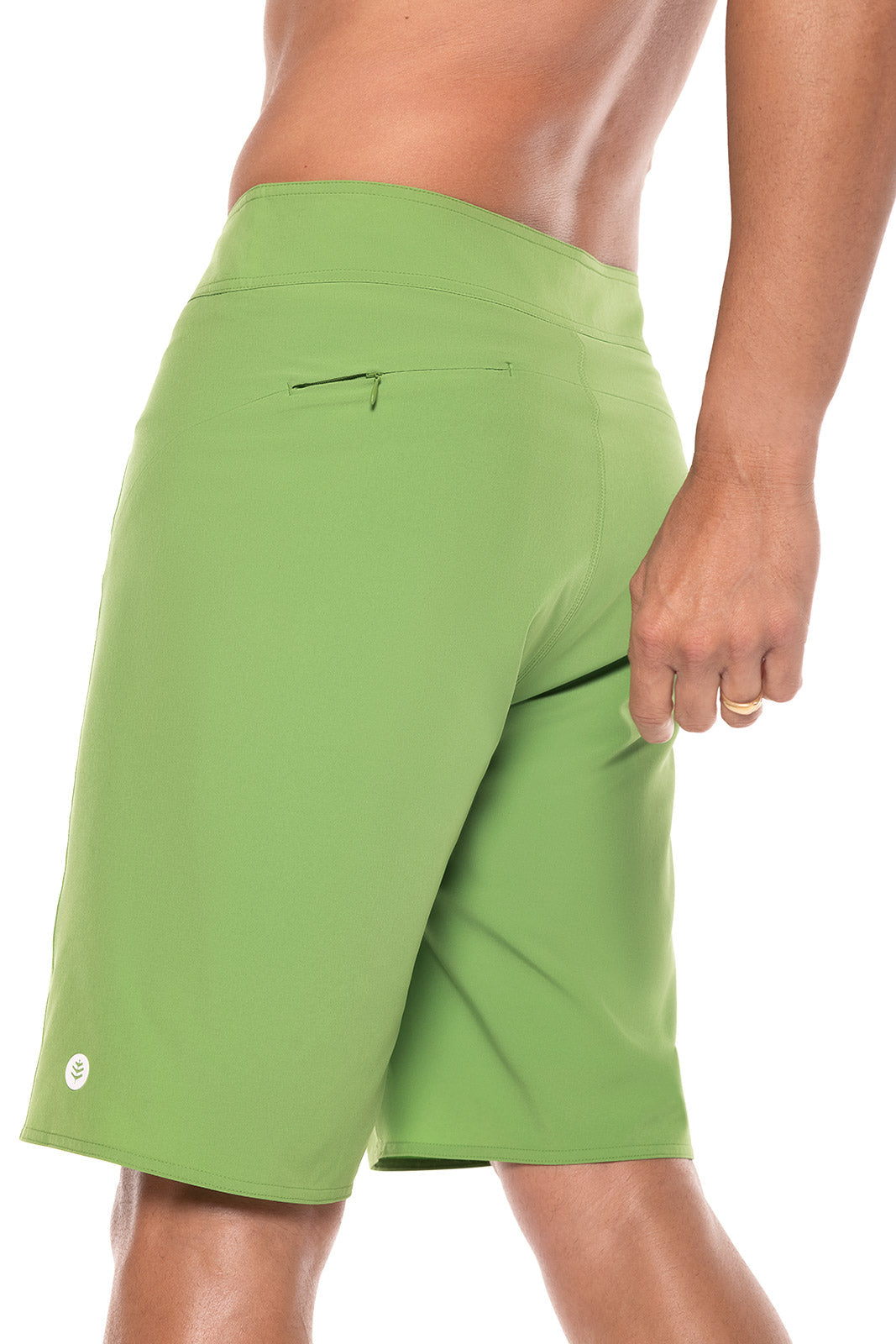 Green shorts worn by a person on a white background