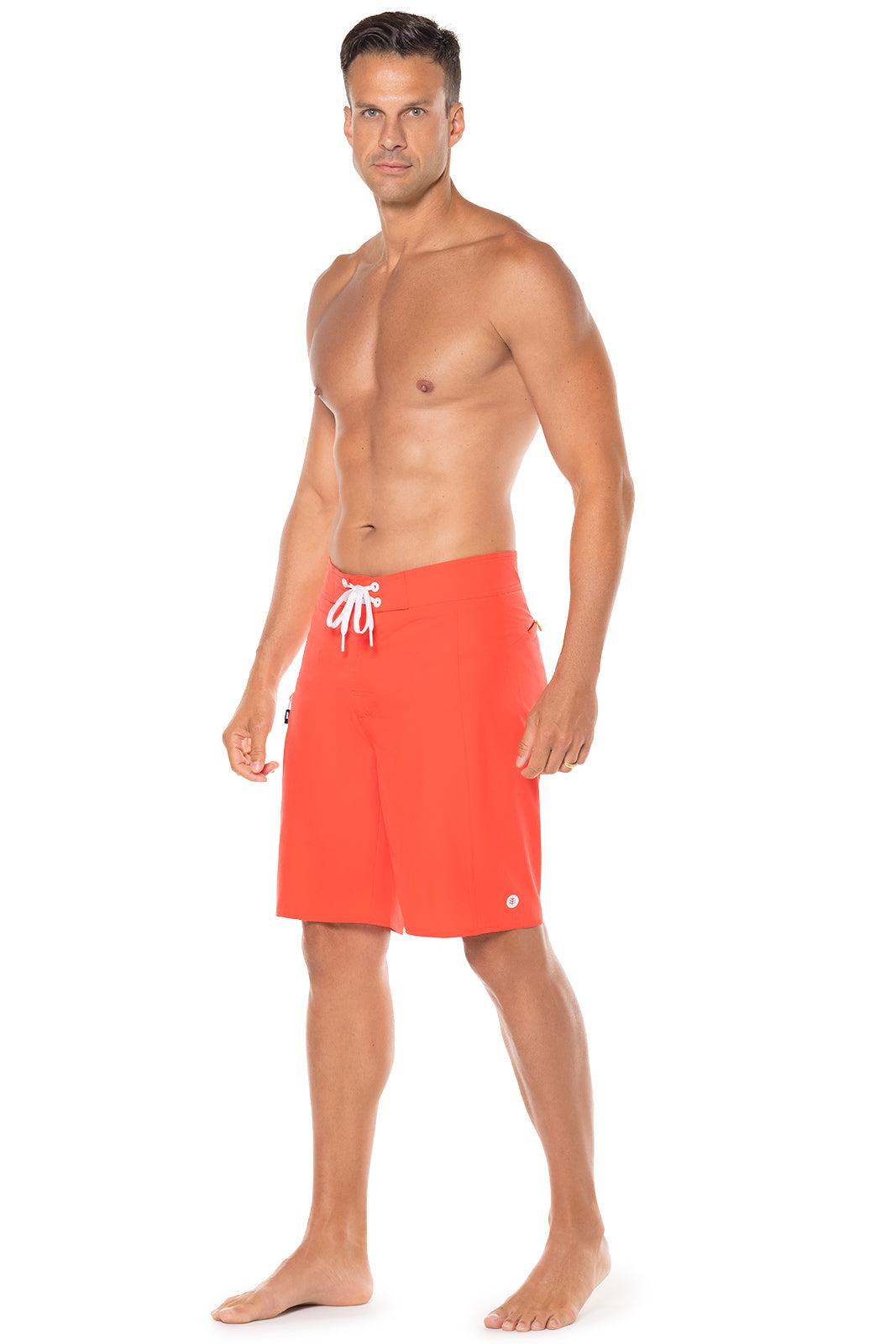 Man wearing bright orange swim shorts with a logo on a white background
