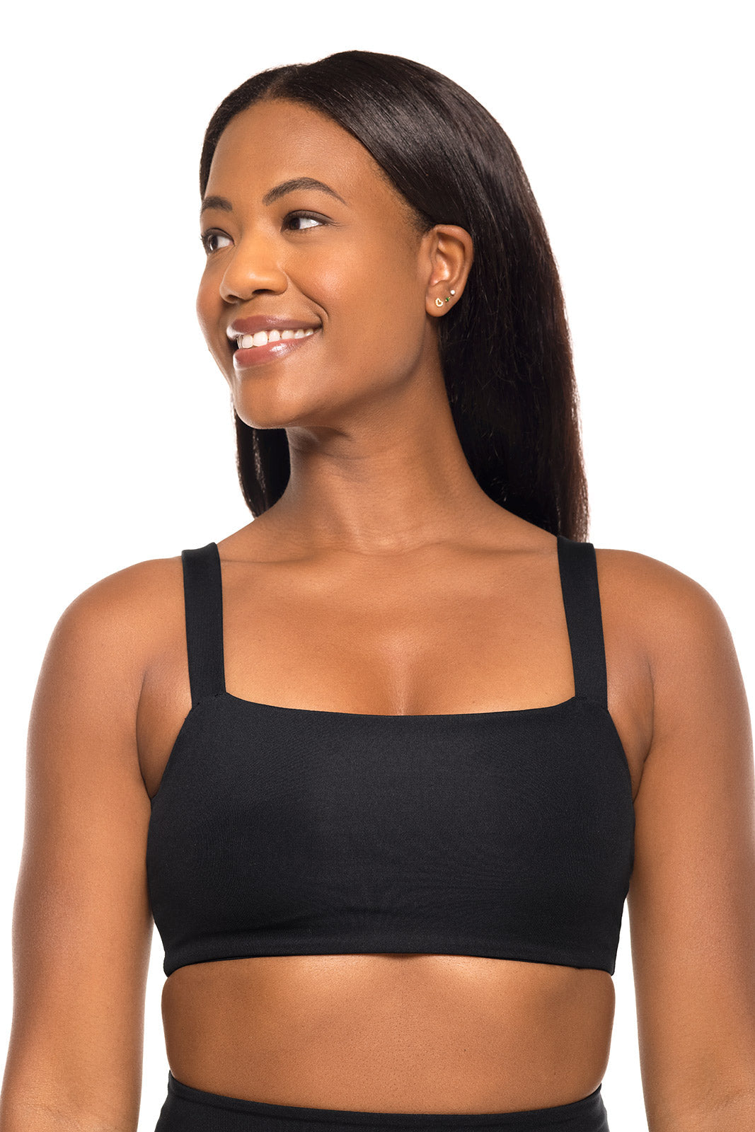 Woman wearing a black sports bra on a white background