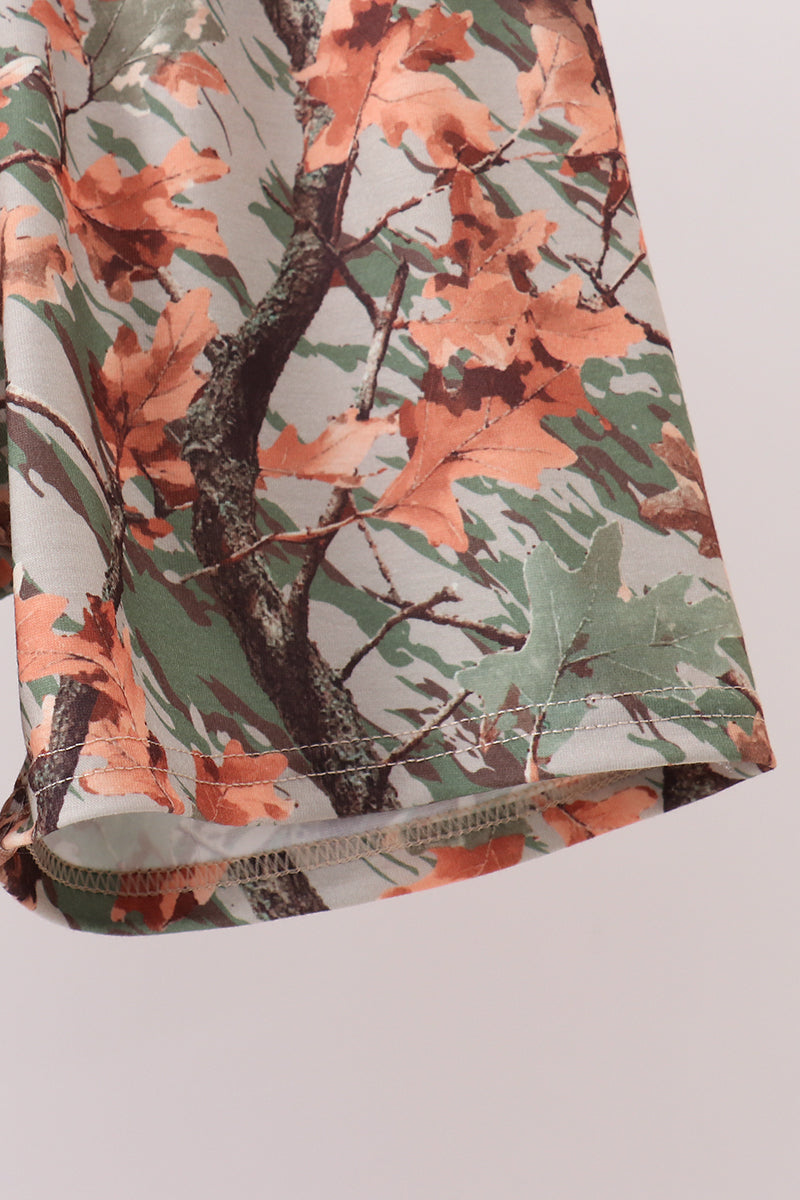 A close-up of a fabric product, likely a sleeve or cuff, featuring an autumn leaf camouflage pattern with orange, green, and brown leaves on a light background.