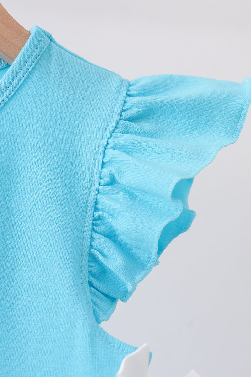 Close-up of a light blue sleeveless top with ruffled flutter sleeves, shown on a hanger against a plain light background.