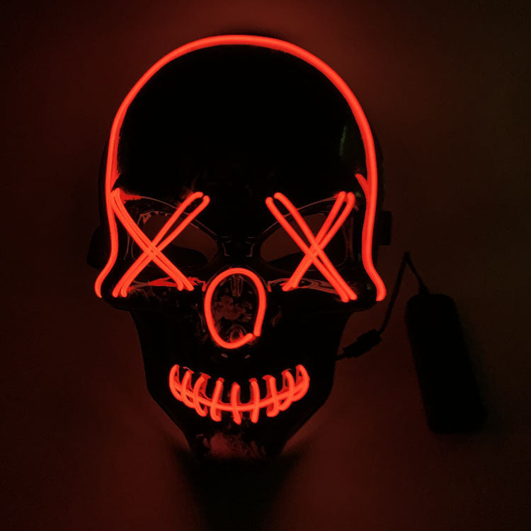 Skull mask with red LED lights on a dark background