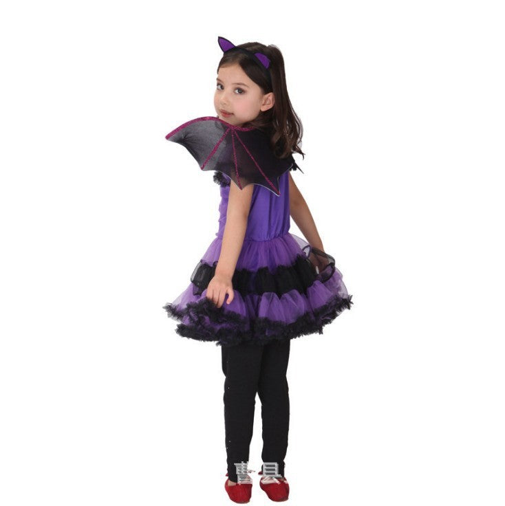 Child wearing a purple and black Halloween costume with a cape on a white background