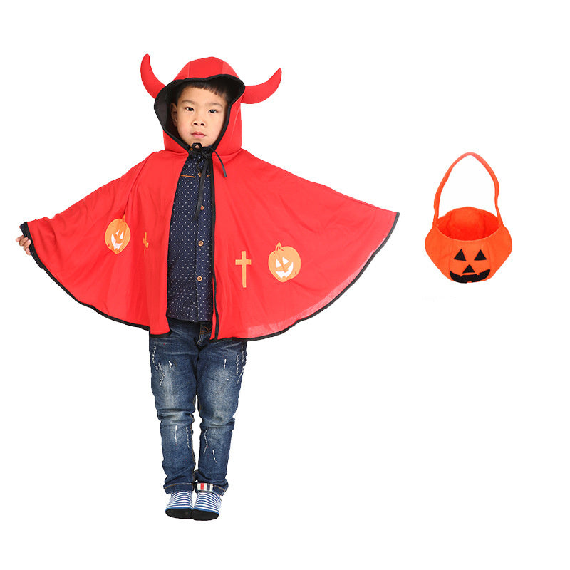 Child wearing a red Halloween cape with pumpkin designs and a matching bucket on a white background