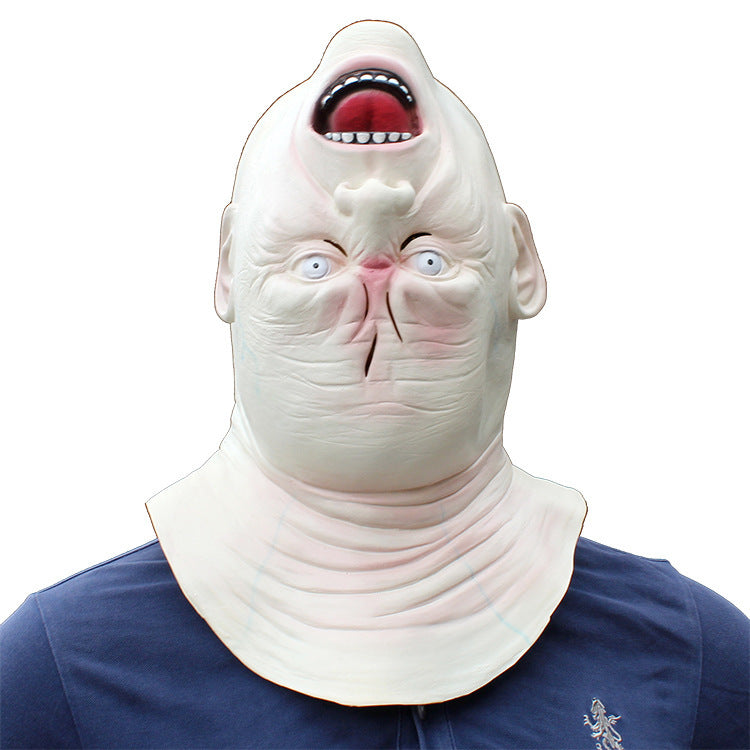 Person wearing a shark-like mask with an open mouth on a white background