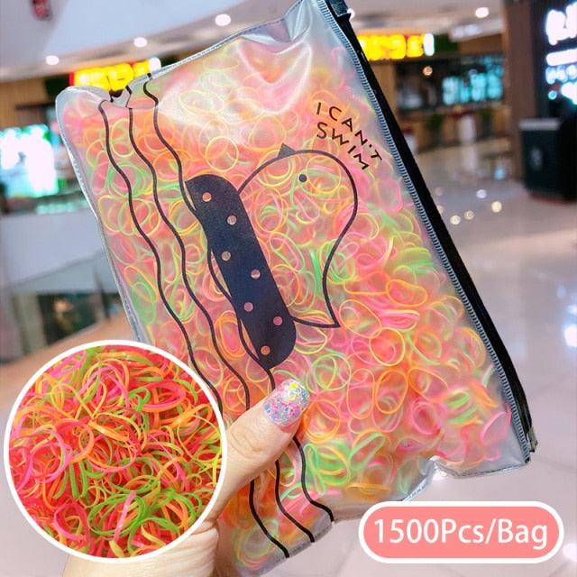 Clear bag with colorful rubber bands and a guitar design, held by a hand.