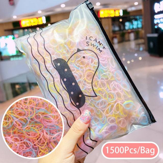 Clear bag with colorful rubber bands and a butterfly design, held by a hand in an indoor setting.