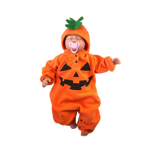 Baby in a pumpkin costume with a white background