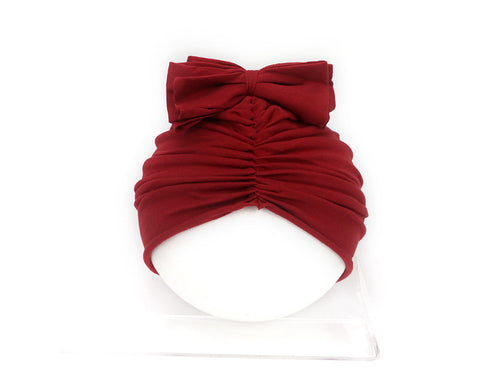 Red turban with a large bow on a white background