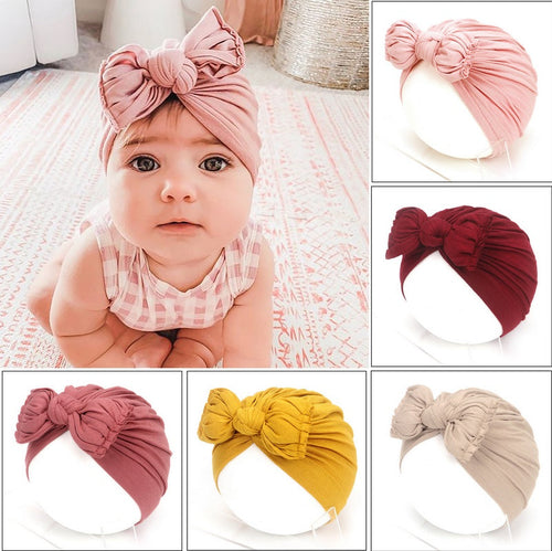 Collage of baby wearing a pink headband with a bow, surrounded by various other headbands in different colors.