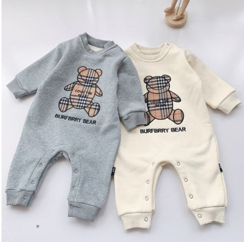 Two baby rompers with Burberry bear designs on a light background
