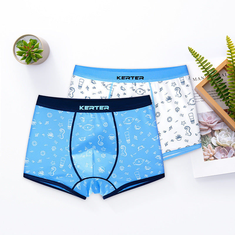 Two pairs of Keter boxer briefs, one blue and one white with patterns, on a white surface.