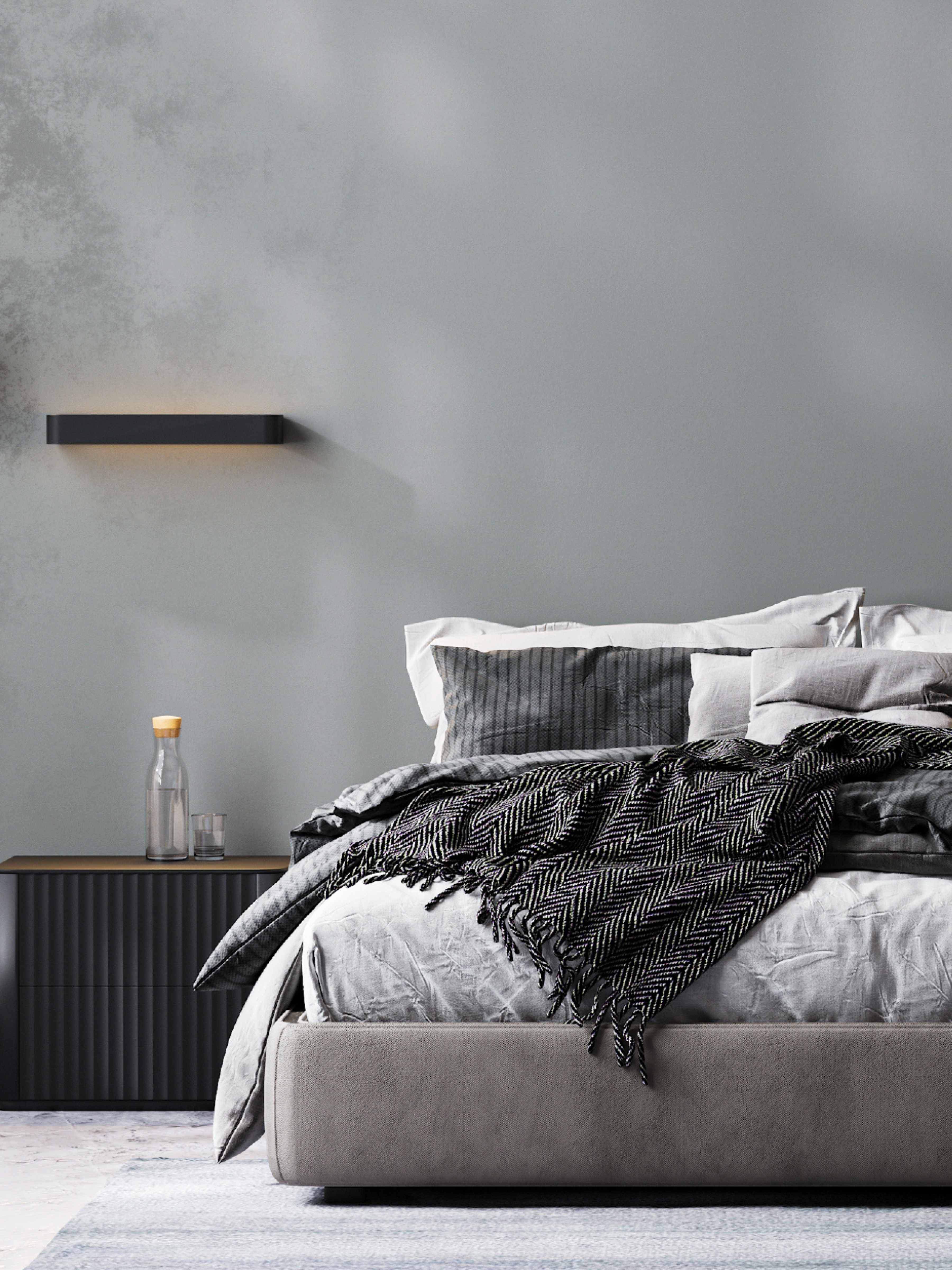 Modern bedroom with a bed, nightstand, and wall light fixture.
