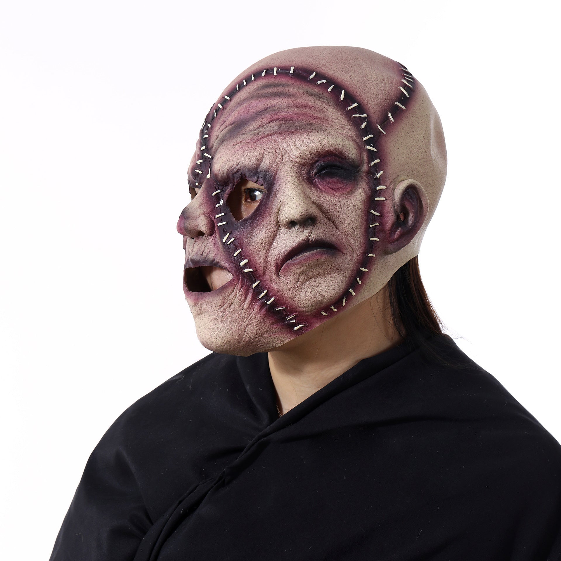 Person wearing a horror-themed mask with a white background