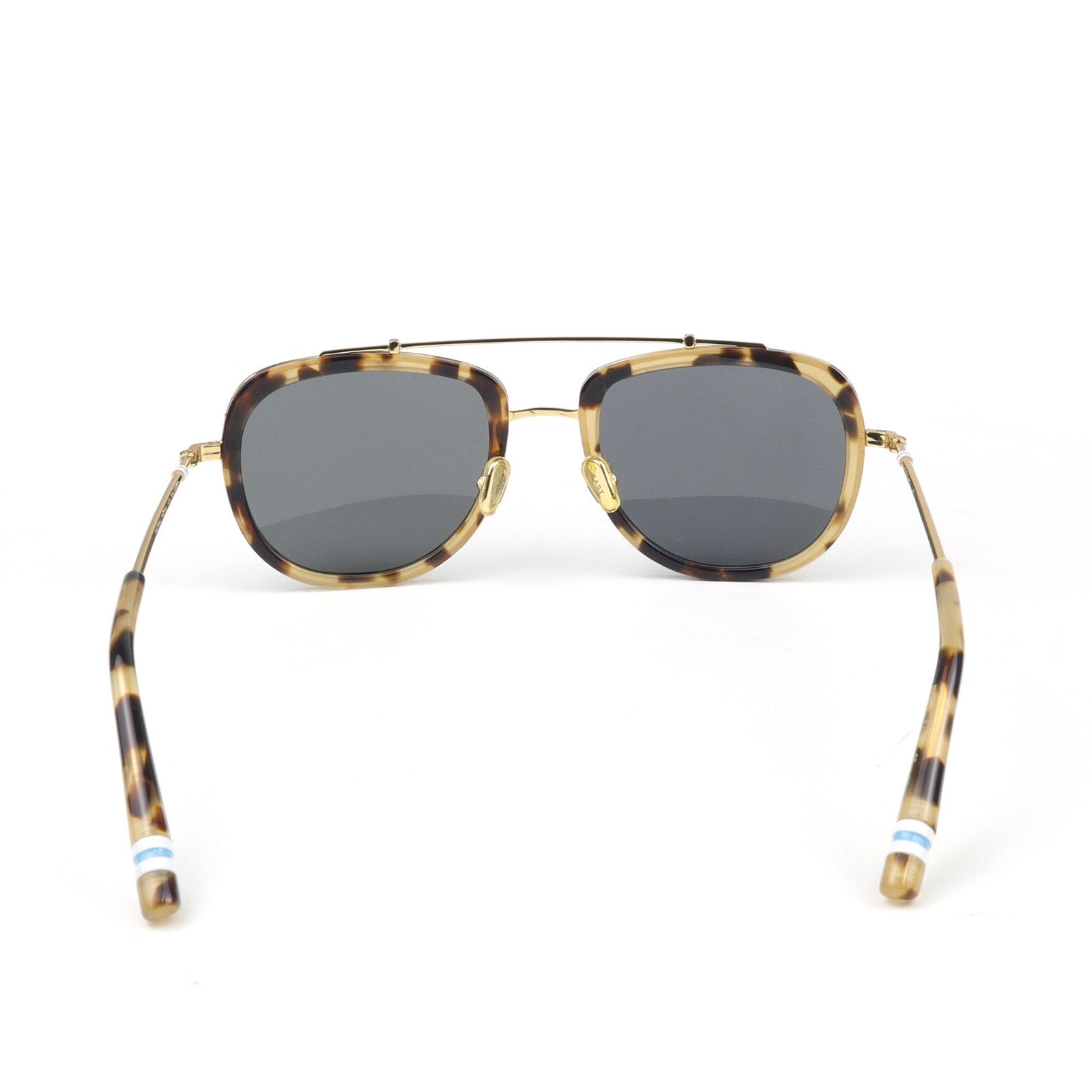 Sunglasses with tortoiseshell frame and dark lenses on a white background