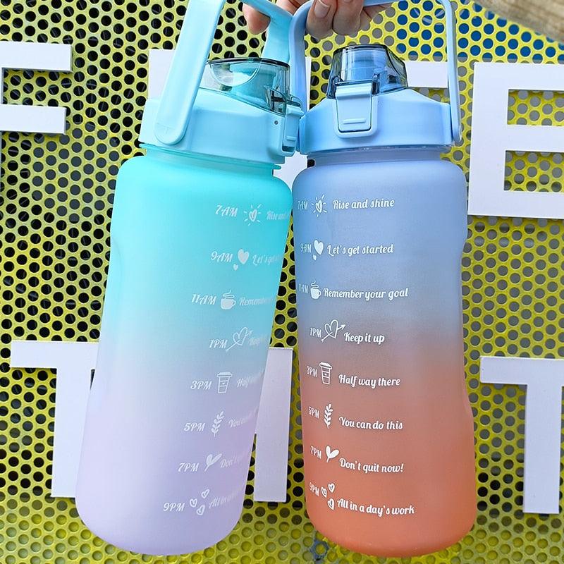 Two gradient water bottles with motivational phrases on a yellow and white background