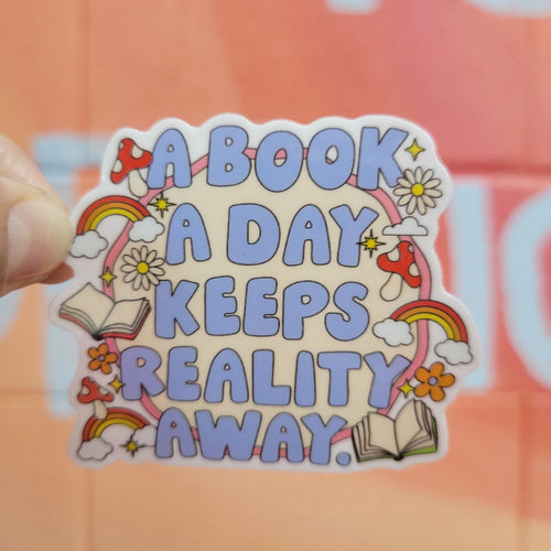 Sticker with 'A book a day keeps reality away' text held against an orange background