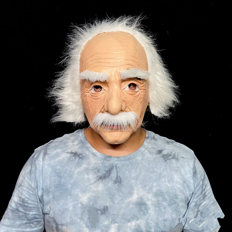 Person wearing a Einstein-style mask with white hair and mustache on a black background
