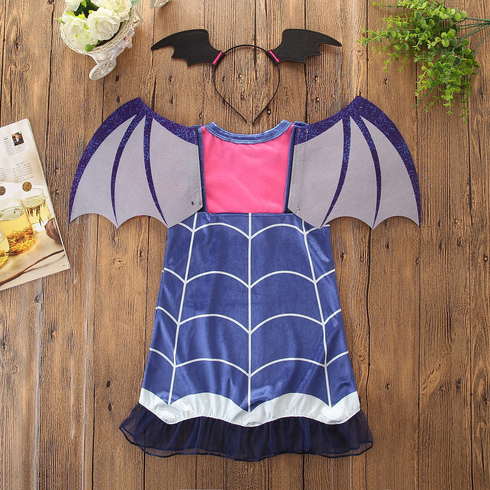 Bat-themed children's dress with wings and headband on a wooden surface