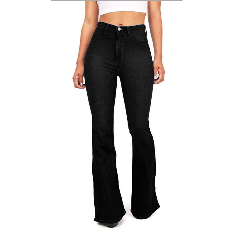 Black flared jeans worn by a person on a white background