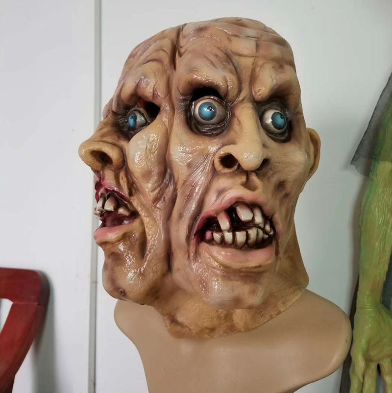 Creepy mask with exaggerated features on a mannequin head against a white background