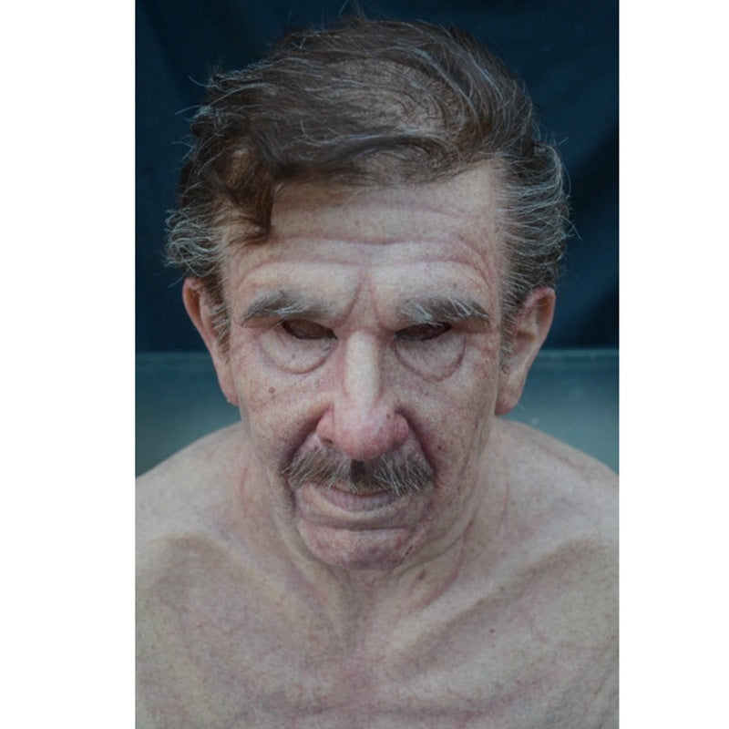 Close-up of a man with a mustache and no shirt on a dark background
