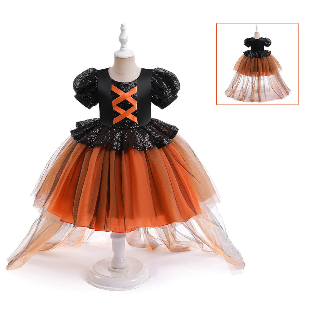 Black and orange dress on a mannequin with an inset showing a close-up of the dress details.